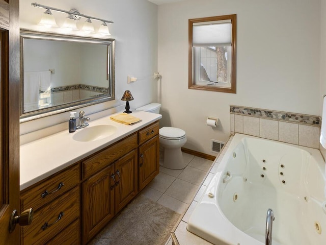 bathroom featuring vanity, a washtub, tile patterned floors, and toilet