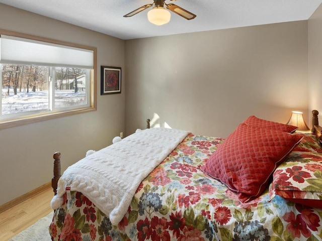 bedroom featuring hardwood / wood-style flooring and ceiling fan