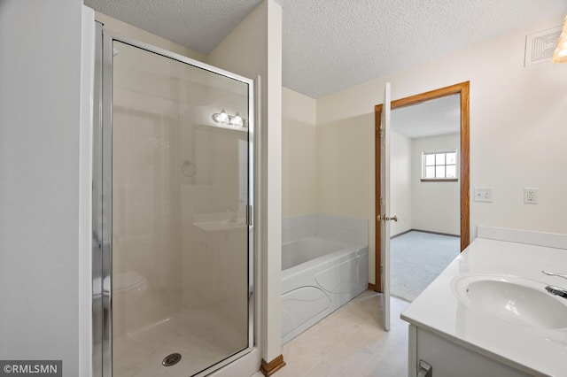 bathroom featuring vanity, plus walk in shower, and a textured ceiling