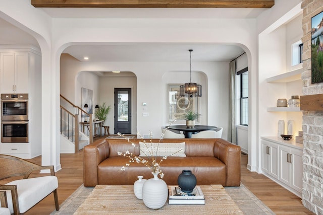 4718 Ordell Trl N, Stillwater, MN 55082 - living area with arched walkways, stairway, light wood finished floors, and plenty of natural light