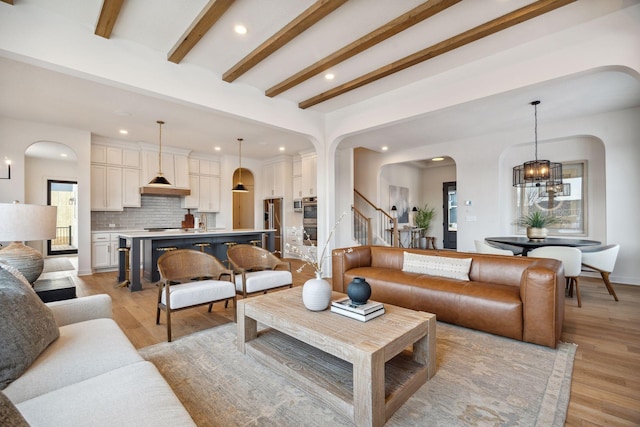 4718 Ordell Trl N, Stillwater, MN 55082 - living room with arched walkways, recessed lighting, light wood finished floors, stairs, and beam ceiling