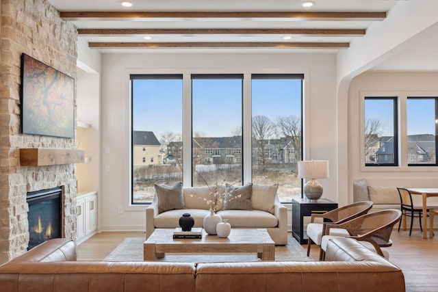 4718 Ordell Trl N, Stillwater, MN 55082 - living area with light wood-type flooring, beamed ceiling, healthy amount of natural light, recessed lighting, and a stone fireplace