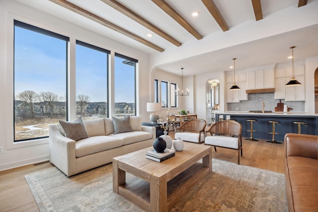 4718 Ordell Trl N, Stillwater, MN 55082 - living area featuring light wood-style floors, recessed lighting, beam ceiling, baseboards, and arched walkways