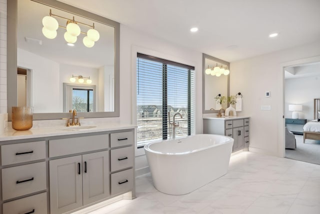 4718 Ordell Trl N, Stillwater, MN 55082 - bathroom with a freestanding tub, marble finish flooring, two vanities, ensuite bathroom, and recessed lighting