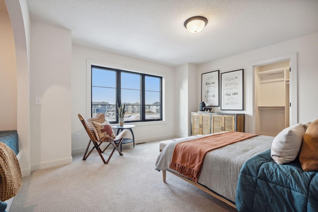 4718 Ordell Trl N, Stillwater, MN 55082 - bedroom featuring carpet flooring, baseboards, a textured ceiling, and a spacious closet