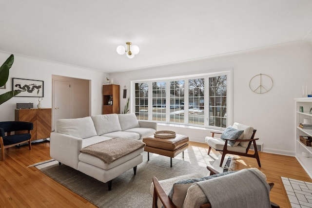 living area with baseboards and light wood-style floors