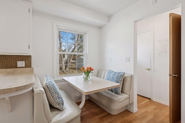 dining area with visible vents, breakfast area, and light wood-style floors