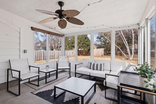 sunroom / solarium with a healthy amount of sunlight and ceiling fan