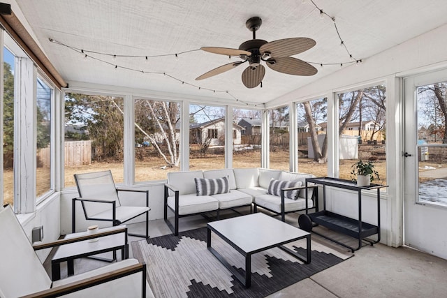 sunroom / solarium featuring a ceiling fan and vaulted ceiling