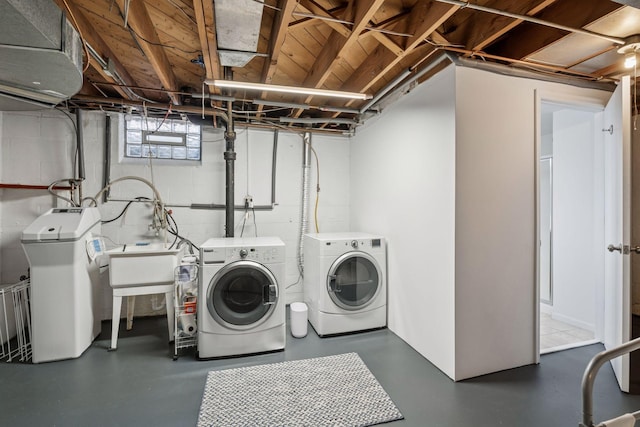 laundry area with a sink, laundry area, and washing machine and clothes dryer