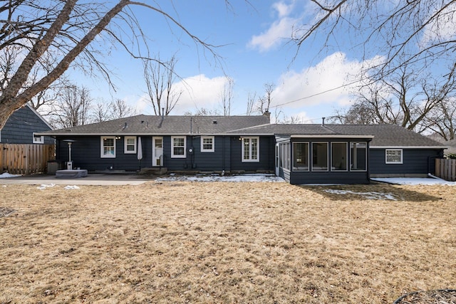 rear view of house with a patio area, fence, and a sunroom