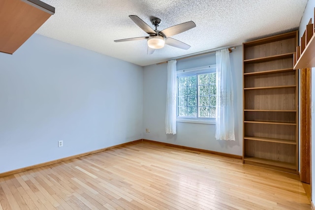 unfurnished room featuring ceiling fan, a textured ceiling, and light hardwood / wood-style flooring