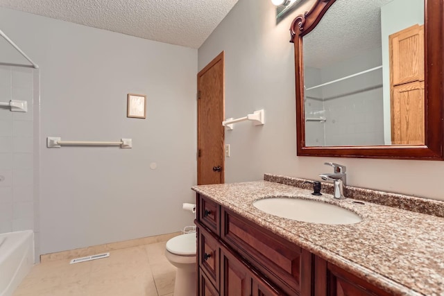 bathroom with vanity, tile patterned flooring, a textured ceiling, and toilet