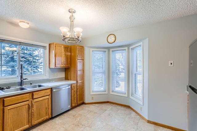 kitchen featuring dishwasher, sink, hanging light fixtures, a notable chandelier, and a textured ceiling