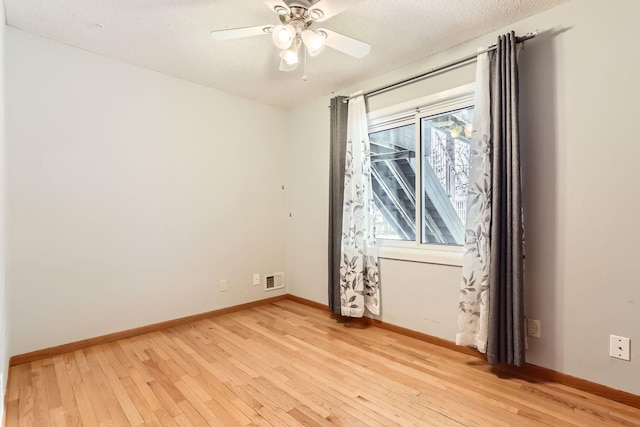 unfurnished room featuring ceiling fan, a textured ceiling, and light hardwood / wood-style flooring