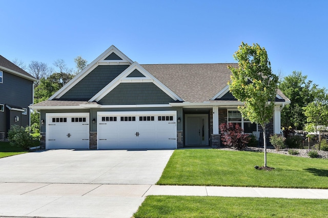 craftsman-style home with a front yard, stone siding, driveway, and an attached garage