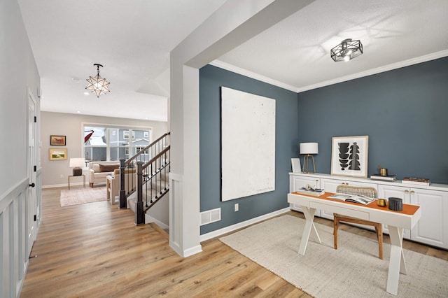 office area with ornamental molding and light hardwood / wood-style floors