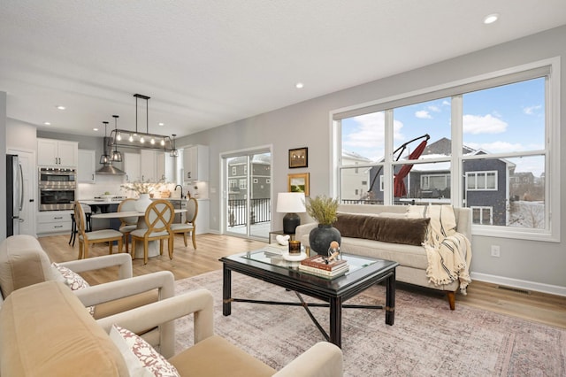 living room featuring light hardwood / wood-style floors and a textured ceiling