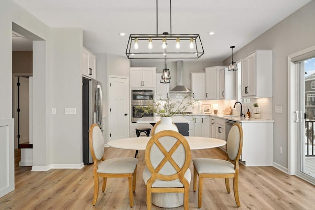 dining area featuring sink and light hardwood / wood-style floors