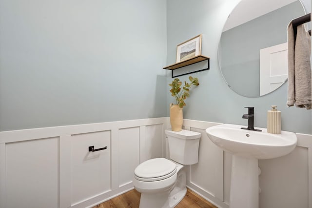 bathroom featuring sink, hardwood / wood-style floors, and toilet