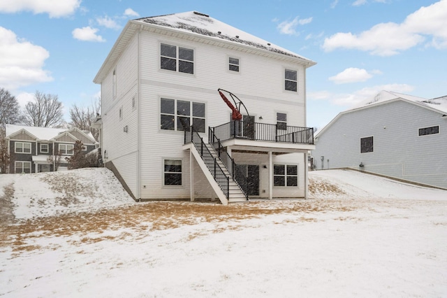 snow covered house featuring a deck