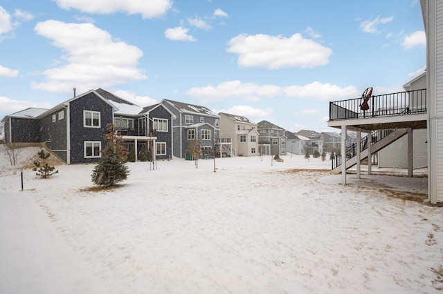 yard layered in snow featuring a wooden deck