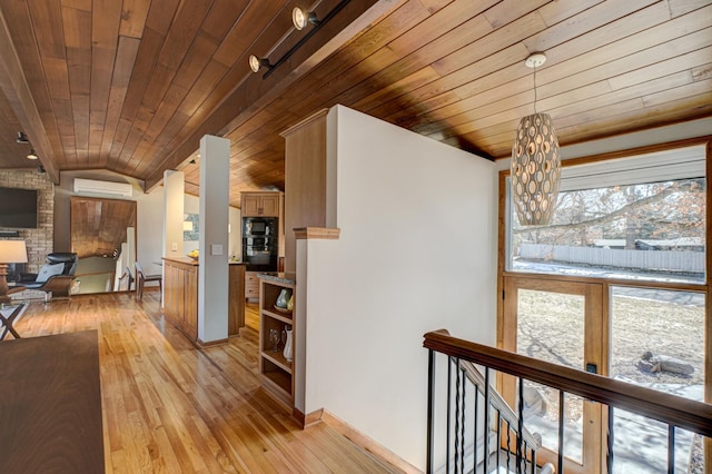 hallway featuring wooden ceiling, an upstairs landing, light wood-style floors, and lofted ceiling