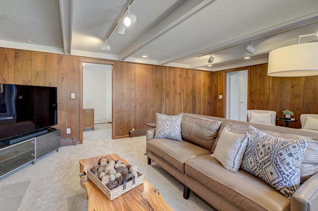 carpeted living room featuring beamed ceiling, a textured ceiling, wooden walls, and a baseboard radiator