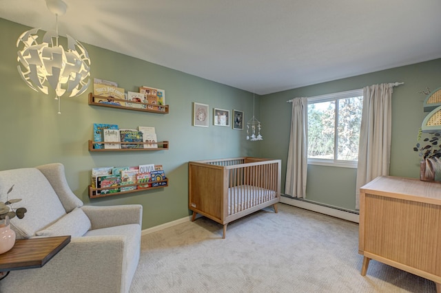 bedroom featuring baseboards, a crib, carpet flooring, a notable chandelier, and baseboard heating