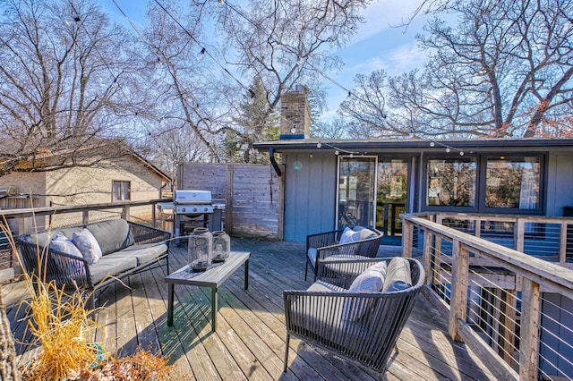 deck featuring an outdoor living space and area for grilling