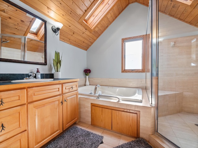 bathroom featuring a shower stall, vanity, a bath, and tile patterned floors