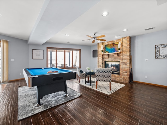 game room with wood finish floors, visible vents, a fireplace, and baseboards