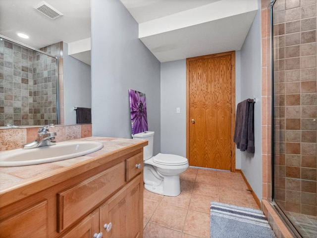 full bathroom featuring visible vents, toilet, a shower stall, vanity, and tile patterned floors