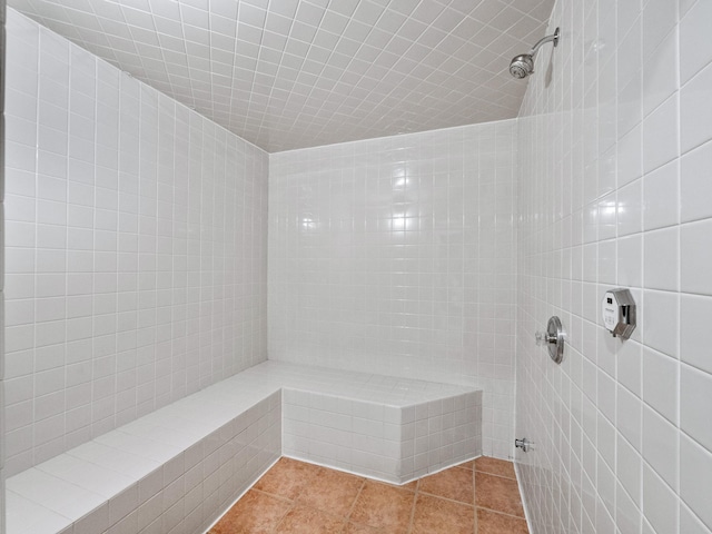 full bathroom with a tile shower and tile patterned floors