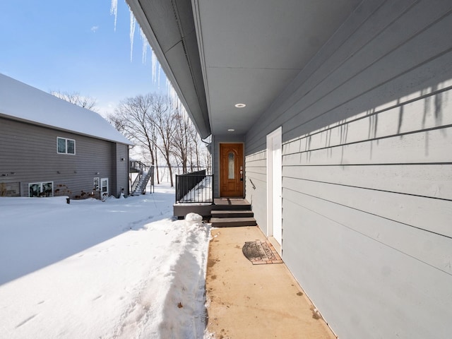 view of snow covered property entrance