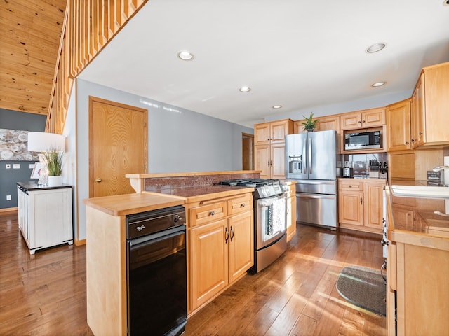 kitchen with a center island, recessed lighting, light brown cabinetry, appliances with stainless steel finishes, and wood finished floors