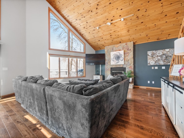 living room with dark wood-style floors, high vaulted ceiling, a stone fireplace, and wood ceiling