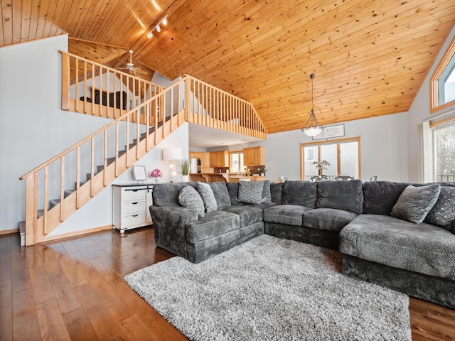 living room with wood ceiling, dark wood finished floors, track lighting, and stairs