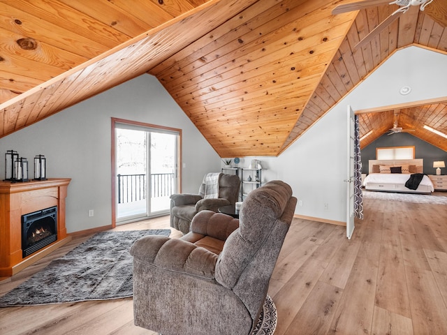 living area with vaulted ceiling, light wood-type flooring, wood ceiling, and a ceiling fan