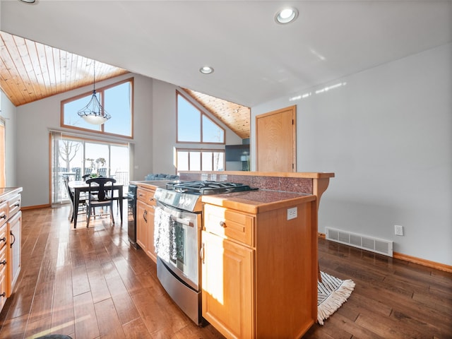 kitchen featuring light brown cabinets, baseboards, visible vents, stainless steel gas range, and dark wood-style flooring