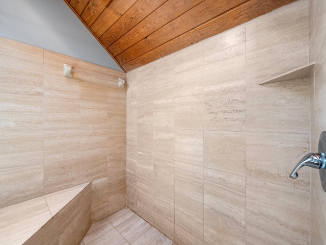 full bath with lofted ceiling, wood ceiling, and a tile shower