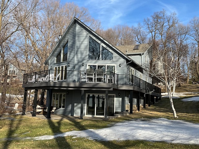 exterior space featuring a wooden deck and a shingled roof