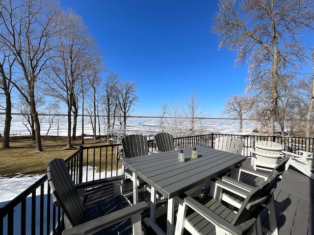 snow covered deck featuring outdoor dining space