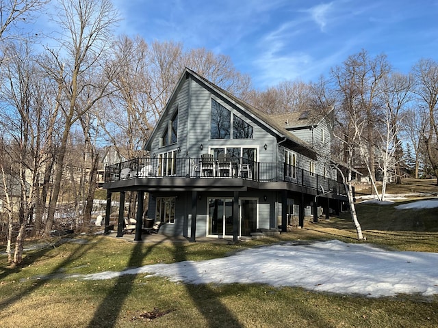 exterior space with a wooden deck and a lawn