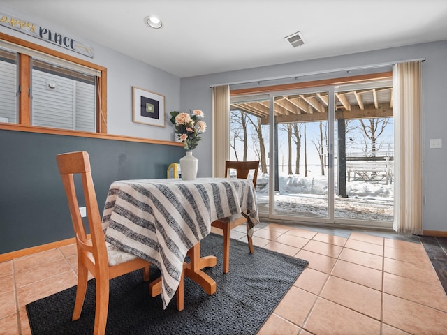 dining space featuring tile patterned floors, visible vents, baseboards, and recessed lighting