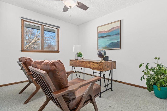 office area featuring a ceiling fan, light colored carpet, a textured ceiling, and baseboards