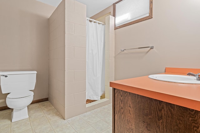 bathroom with toilet, a shower stall, and vanity