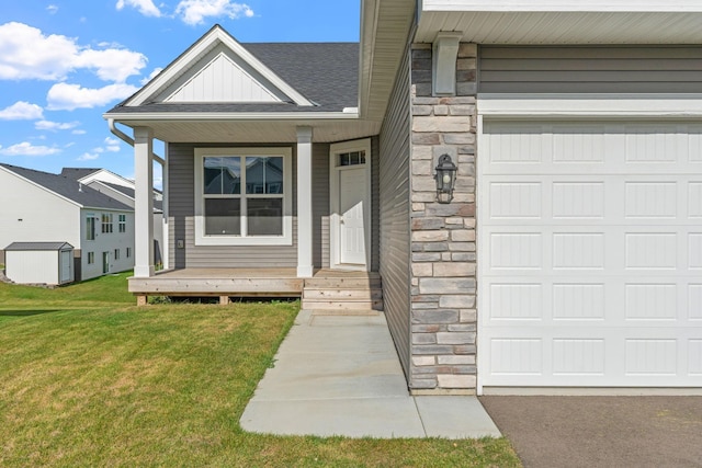 doorway to property with stone siding, a lawn, an attached garage, and board and batten siding