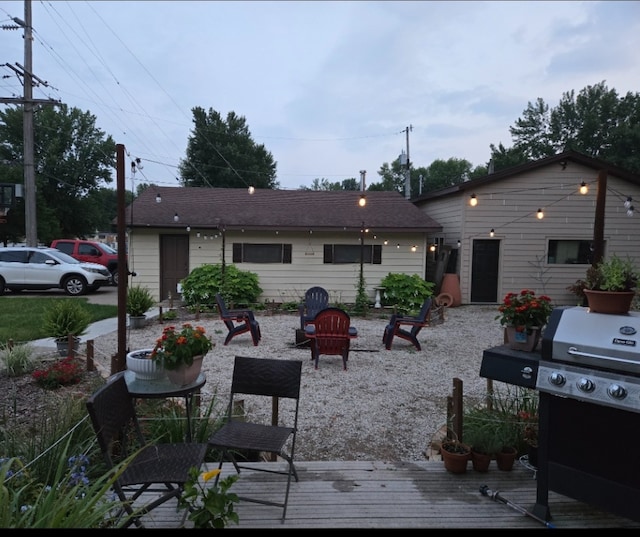 rear view of property with a fire pit