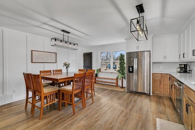 dining room featuring visible vents and light wood-type flooring